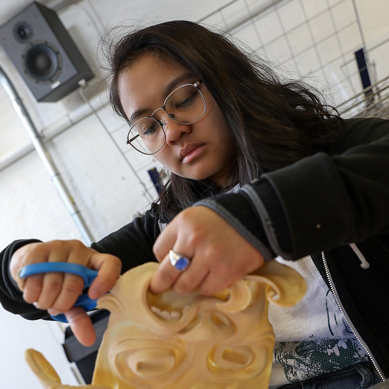 student working on a sculpture