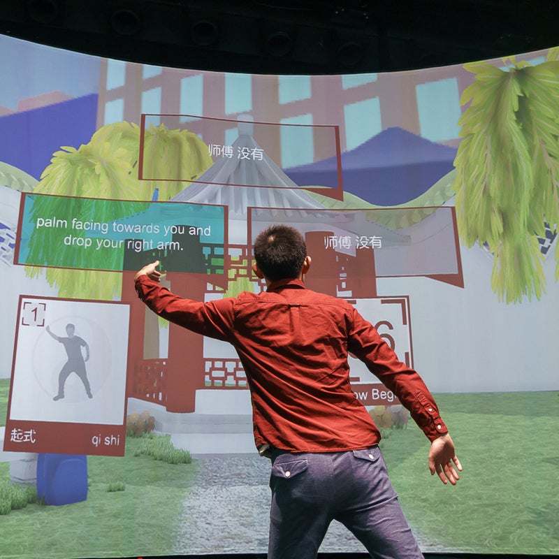 Student interacting with a VR program on a large screen