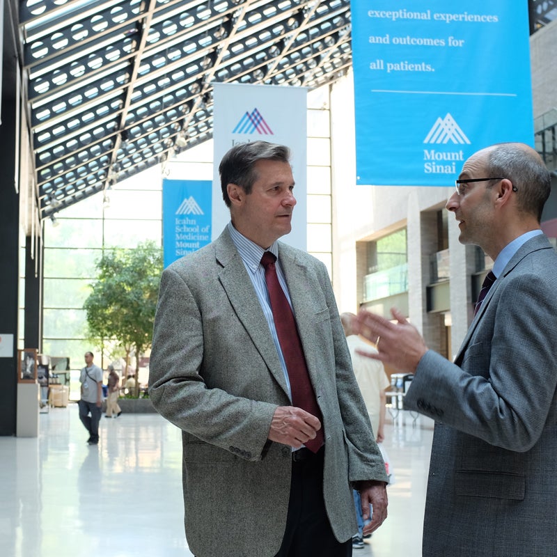 Two men having a conversation in lobby area of Mount Sinai Hospital