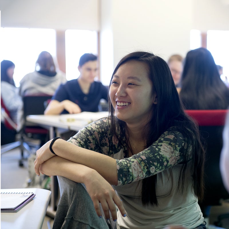 Smiling student in a classroom environment