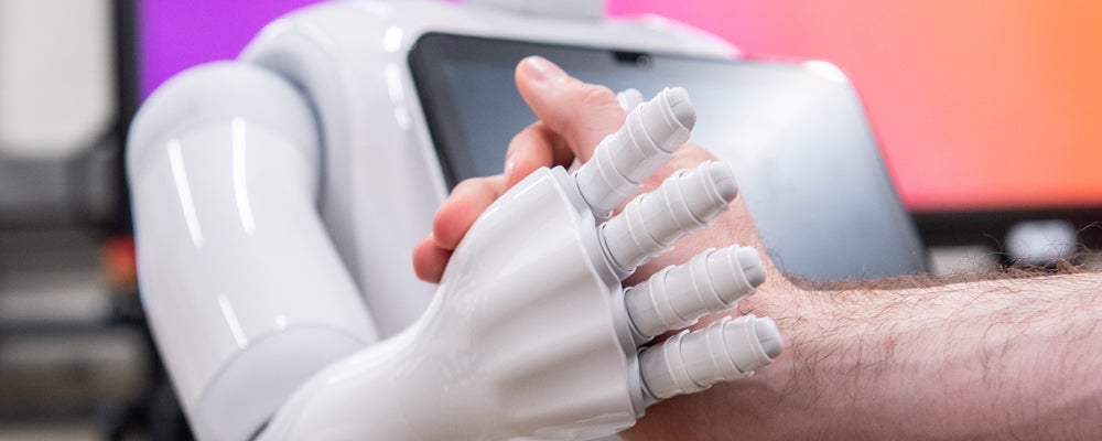 Man shaking hands with a robot