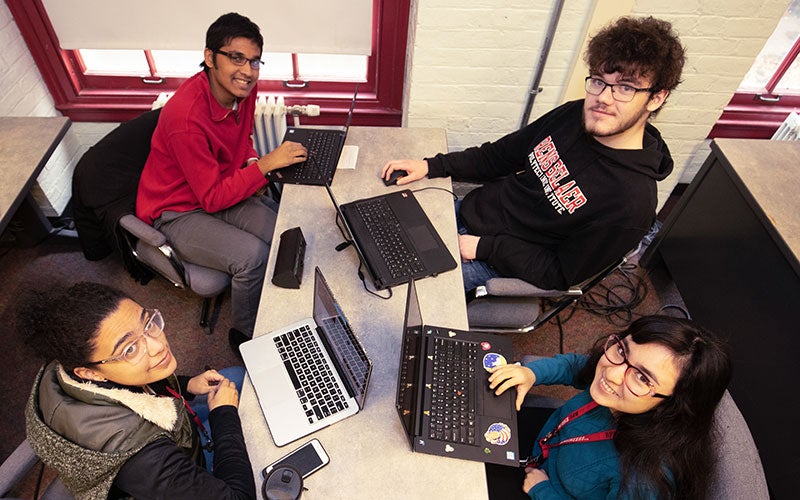 Four students participating in a writing assignement