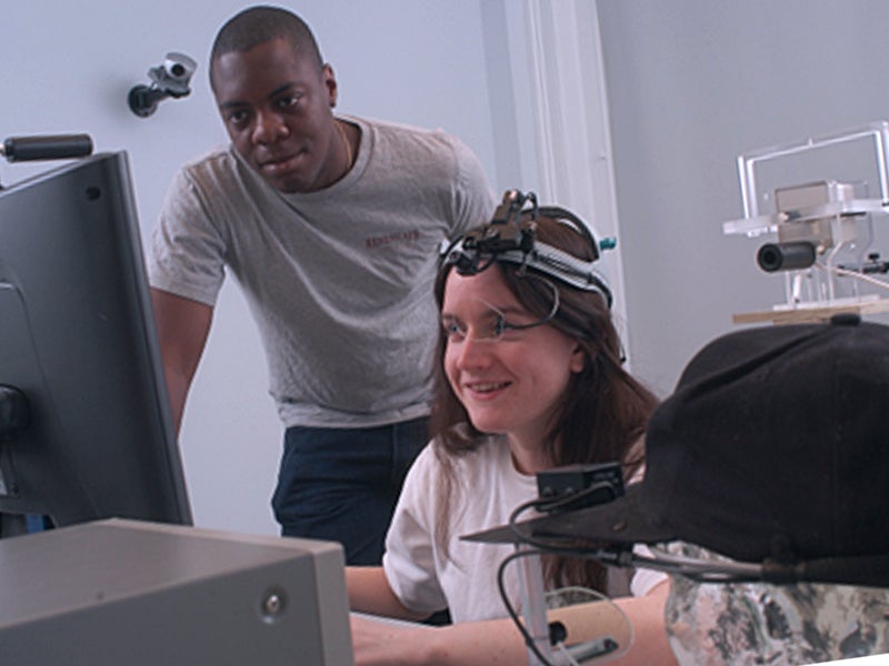 Two students, a male and a female, working with perception technology