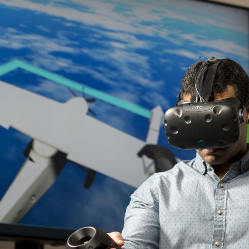 Student with VR goggles on in a flight simulation game