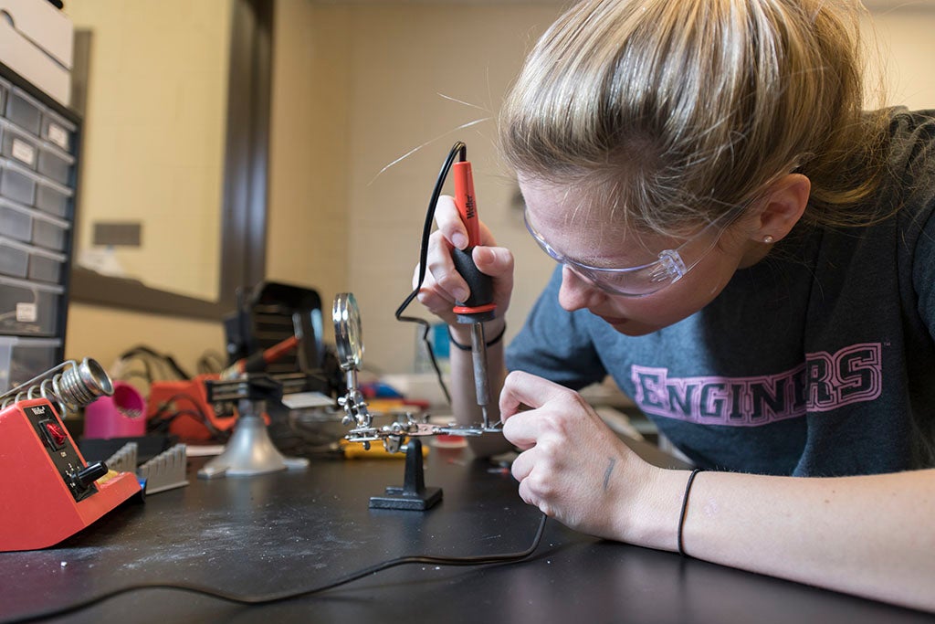 a student working at a soldering work station