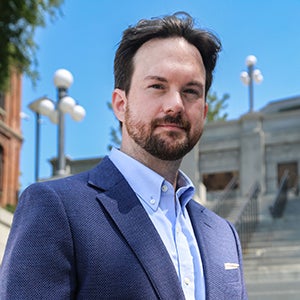 Dean Will Gibbons wearing a blue shirt and jacket