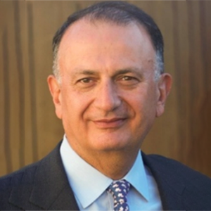 Saied Seghatoleslami, a man wearing a dark jacket, blue shirt, and blue and white tie