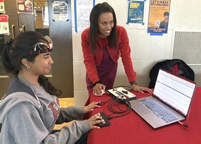 Professor Berry works with a student