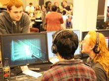 students sitting around a computer while gaming